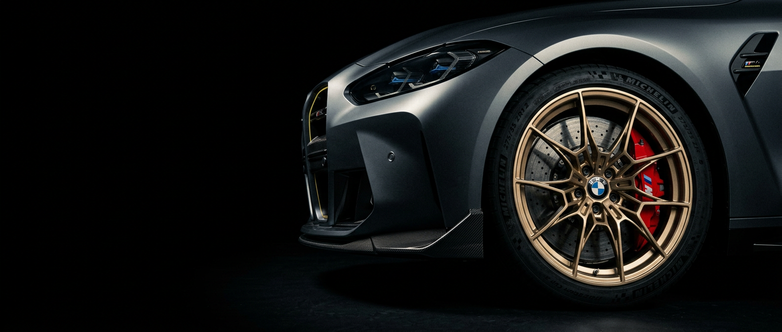 Front three-quarter detail of a BMW M4 G82 with gold forged wheel and red brake caliper
