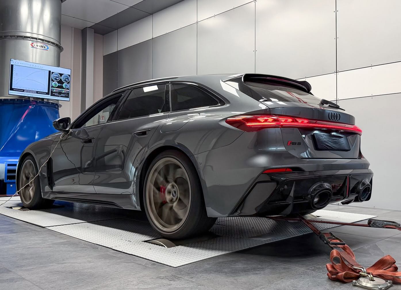 Grey Audi RS5 Avant strapped to the chassis dynamometer with the power curve on the cell monitor