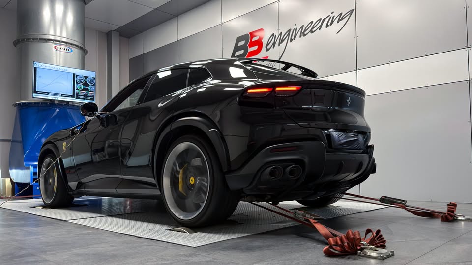 Black Ferrari Purosangue strapped down on the chassis dynamometer