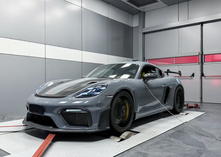 Grey Porsche 718 Cayman GT4 RS strapped down on the dyno